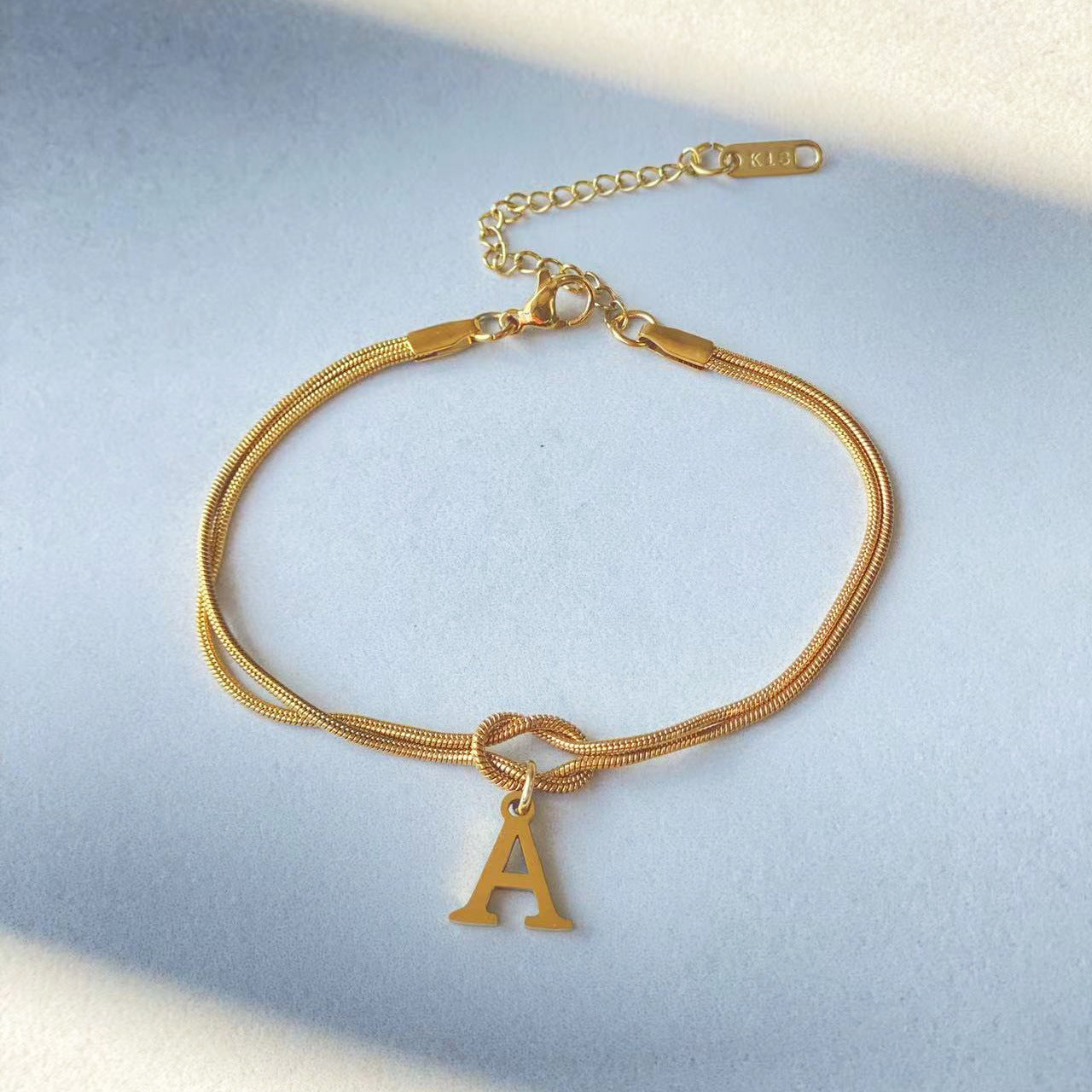 A-Z Love Knot Bracelet – Personalized Gold Charm