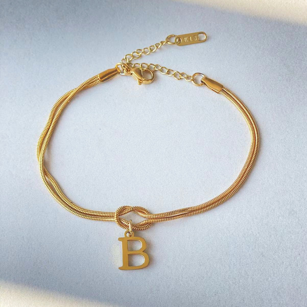 A-Z Love Knot Bracelet – Personalized Gold Charm